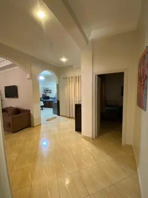 a large living room with a couch and a table at Spacieux & confortable, parfait pour familles ou séjours tranquilles in Marrakech