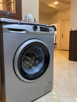a white washing machine sitting in a room at Spacieux & confortable, parfait pour familles ou séjours tranquilles in Marrakech