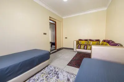 a bedroom with a bed and a couch at Modern and Convenient Apartment in Marrakech