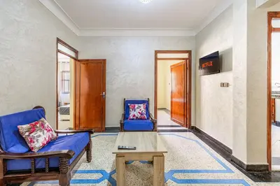 a living room with a couch and a chair at Modern and Convenient Apartment in Marrakech