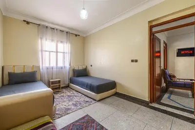 a room with two beds and a window at Modern and Convenient Apartment in Marrakech