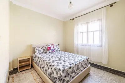 a bedroom with a bed and a window at Modern and Convenient Apartment in Marrakech