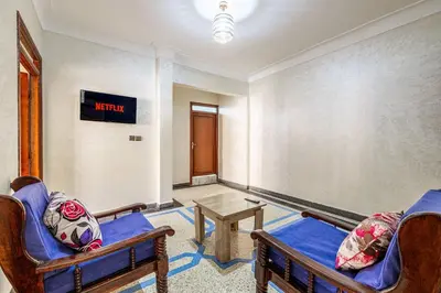 a living room with two chairs and a table at Modern and Convenient Apartment in Marrakech