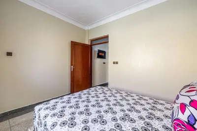 a bedroom with a bed in a room with a door at Modern and Convenient Apartment in Marrakech