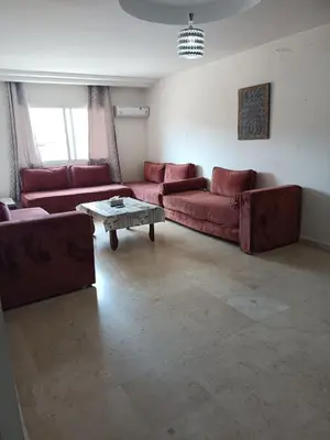 a living room with red couches and a coffee table at family apartment 8 in Marrakech