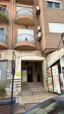 a building with stairs and a door and a balcony at family apartment 8 in Marrakech