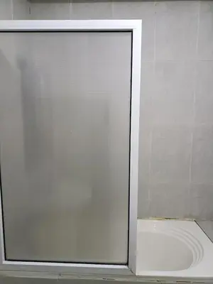 a glass door of a shower in a bathroom at family apartment 8 in Marrakech