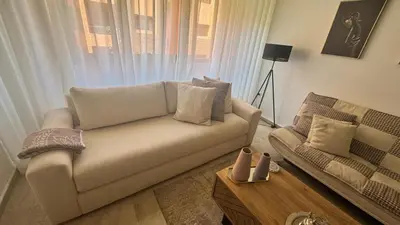 a living room with a couch and a coffee table at Modern apartment in City center in Marrakech