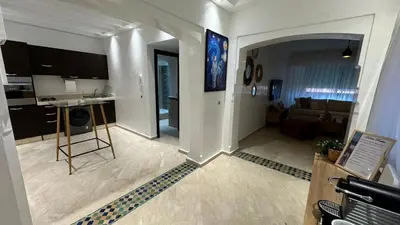 a living room with a kitchen and a living room at Modern apartment in City center in Marrakech