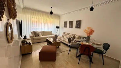 a living room with a couch and a table at Modern apartment in City center in Marrakech