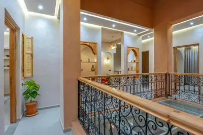 a staircase in a home with a wrought iron railing at ALKHAYMA Medina in Marrakech