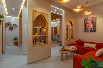 a living room with a red couch and a table at ALKHAYMA Medina in Marrakech