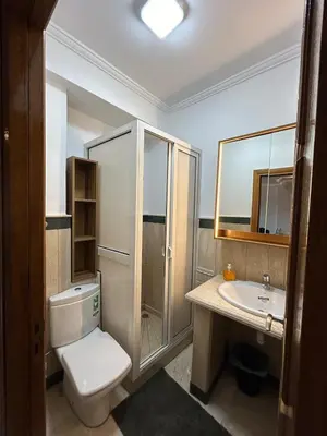 a bathroom with a toilet and a sink at 2-bedroom luxury contemporary apartment Hivernage in Marrakech