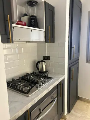 a kitchen with a stove with a tea kettle on it at 2-bedroom luxury contemporary apartment Hivernage in Marrakech