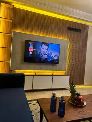 a living room with a tv on a wall at 2-bedroom luxury contemporary apartment Hivernage in Marrakech