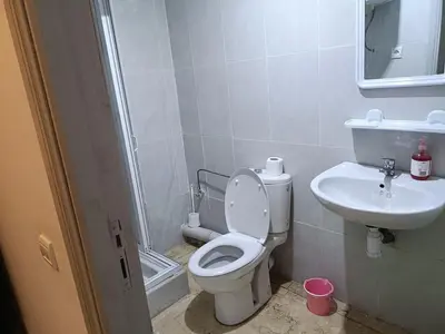 a bathroom with a toilet and a sink at 30 family apartment in Marrakech