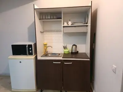 a small kitchen with a sink and a microwave at 30 family apartment in Marrakech