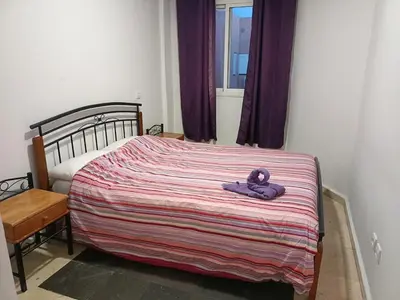 a teddy bear laying on a bed in a bedroom at 30 family apartment in Marrakech