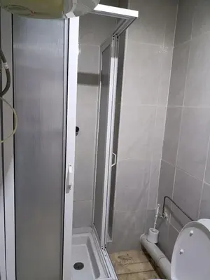 a small bathroom with a shower and a toilet at 30 family apartment in Marrakech