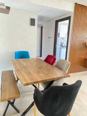 a wooden table and chairs in a room at Appartement cosy à Marrakech in Marrakech