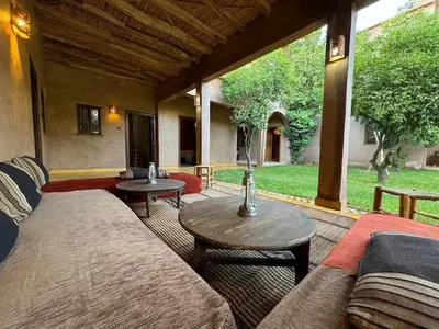 a living room with a couch and a table at DAR EL KERMA Traditional Rustic House in Châba