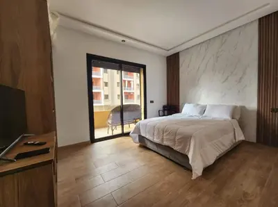 a bedroom with a bed and a large window at Charming Studio in Marrakech 2 min from the train station in Marrakech