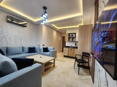 a living room with a couch and a table at Charming Studio in Marrakech 2 min from the train station in Marrakech