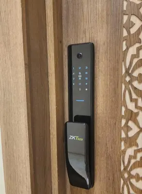 a remote control sitting on top of a wooden door at Charming Studio in Marrakech 2 min from the train station in Marrakech