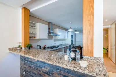 a kitchen with a stone counter top in a room at Your Haven of Peace with Private Jacuzzi in Marrakech