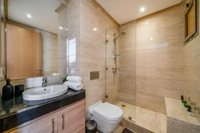 a bathroom with a toilet and a sink and a shower at Your Haven of Peace with Private Jacuzzi in Marrakech