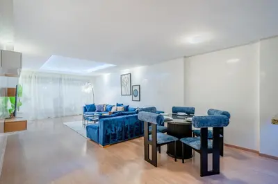 a living room with a couch and a table and chairs at Your Haven of Peace with Private Jacuzzi in Marrakech