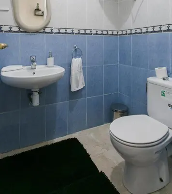 a bathroom with a toilet and a sink at La Perle Blanche Gueliz in Marrakech