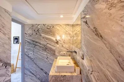 a bathroom with a sink and a marble wall at Luxury Oasis 2 Bedroom and Free Parking in Hivernage in Marrakech