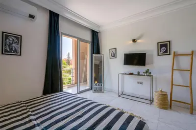 a bedroom with a bed and a large window at Luxury Oasis 2 Bedroom and Free Parking in Hivernage in Marrakech