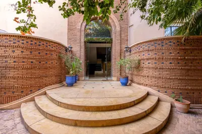 a brick wall with steps in front of a building at Luxury Oasis 2 Bedroom and Free Parking in Hivernage in Marrakech