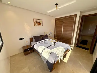 a bedroom with a large bed and a window at Appartement 2 chambres Résidence Atlassi derrière Carré Eden en plein coeur de Gueliz in Marrakech