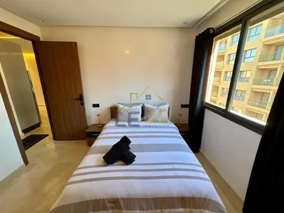 a large bed in a room with a large window at Appartement 2 chambres Résidence Atlassi derrière Carré Eden en plein coeur de Gueliz in Marrakech