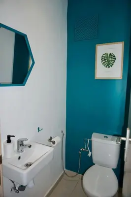 a bathroom with a white toilet and a sink at Appartement moderne rénové in Marrakech