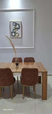 a dining room table and chairs with a table and a picture at Appartement moderne rénové in Marrakech