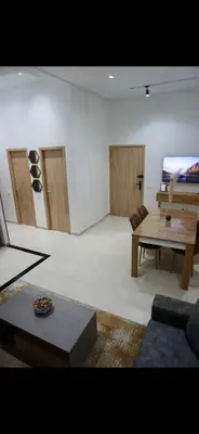a living room with a couch and a table at Appartement moderne rénové in Marrakech
