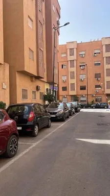 a row of cars parked in a parking lot at Appartement moderne rénové in Marrakech