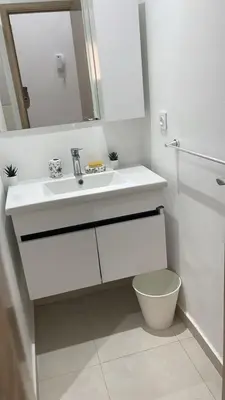a white bathroom with a sink and a toilet at Appartement moderne rénové in Marrakech