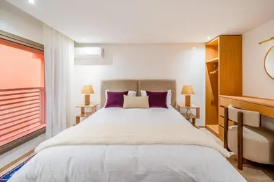 a bedroom with a large bed with purple pillows at Stayin 3Bedroom Duplex in Marrakech