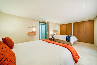 a large bedroom with two beds and a window at Stayin 3Bedroom Duplex in Marrakech