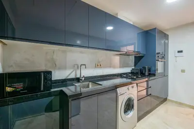 a kitchen with a washing machine and a sink at Stayin 3Bedroom Duplex in Marrakech