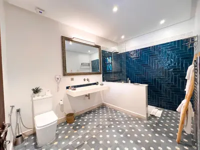 a bathroom with a sink and a shower with a mirror at Riad Kech One & Spa in Marrakech
