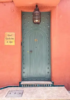 a green door on a building with a sign on it at Riad Kech One & Spa in Marrakech