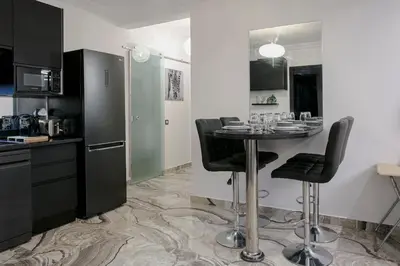a kitchen with a table and chairs in a room at A Stay To Remember - Marrakech Downtown in Marrakech
