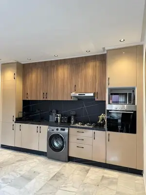 a kitchen with a washing machine and a washer at Appart haut standing - centre ville in Marrakech