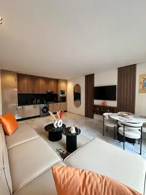 a living room with a couch and a table at Appart haut standing - centre ville in Marrakech